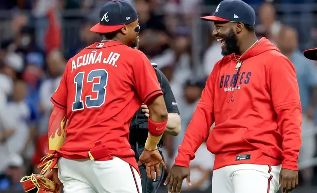 Atlanta Braves' Ronald Acuna Jr. (13) and Michael Harris II, right, celebrate after their team defeated the Philadelphia Phillies in a baseball game, Friday, April 24, 2026, in Atlanta. (AP Photo/Erik S. Lesser)
