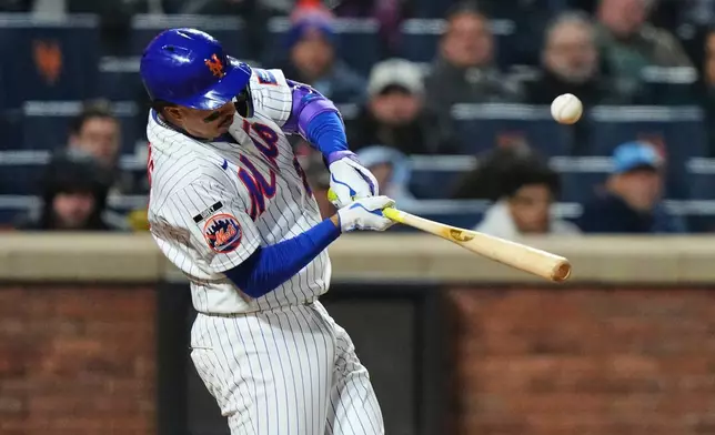 New York Mets' Mark Vientos hits an RBI single during the eighth inning of a baseball game against the Minnesota Twins Wednesday, April 22, 2026, in New York. (AP Photo/Frank Franklin II)