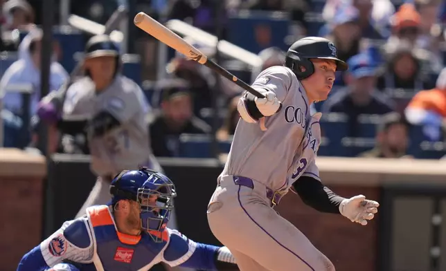 Colorado Rockies' Jake McCarthy looks after an RBI single during the seventh inning of the first baseball game of a doubleheader against the New York Mets, Sunday, April 26, 2026, in New York. (AP Photo/Seth Wenig)
