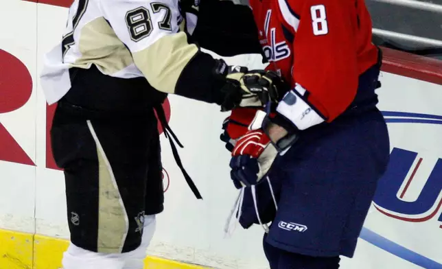 FILE - Pittsburgh Penguins center Sidney Crosby (87) exchanges words with Washington Capitals left wing Alex Ovechkin (8) during the first period of an NHL hockey game, Sunday, Feb., 22, 2009, in Washington. (AP Photo/Pablo Martinez Monsivais, File)