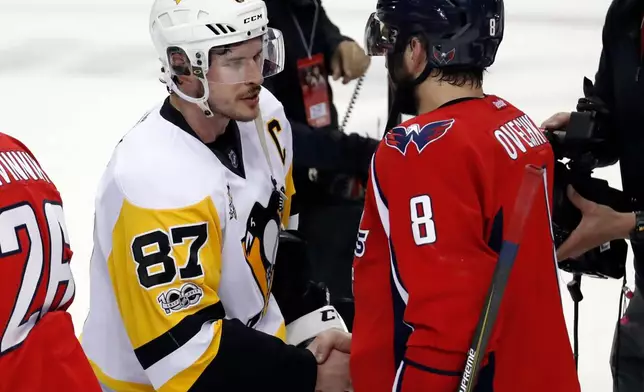 FILE - Washington Capitals left wing Alex Ovechkin (8), from Russia, talks with Pittsburgh Penguins center Sidney Crosby (87) after Game 7 in an NHL hockey Stanley Cup Eastern Conference semifinal, Wednesday, May 10, 2017, in Washington. (AP Photo/Alex Brandon, File)