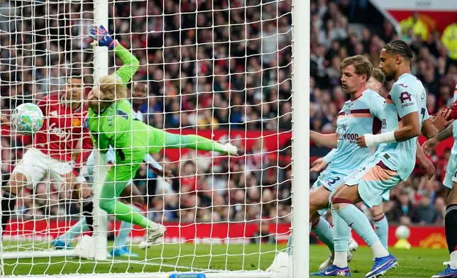 Brentford's goalkeeper Caoimhin Kelleher fails to save first goal during the Premier League soccer match between Manchester United and Brentford in Manchester, England, Monday, April 27, 2026. (AP Photo/Dave Thompson)