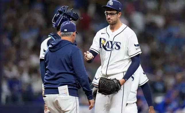 Tampa Bay Rays pitcher Joe Boyle, right, hands the ball to manager Kevin Cash as he is taken out of the game against the Chicago Cubs during the fifth inning of a baseball game Wednesday, April 8, 2026, in St. Petersburg, Fla. (AP Photo/Chris O'Meara)