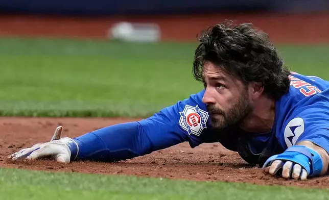 Chicago Cubs' Dansby Swanson reacts after scoring on a two-run double by Michael Conforto off Tampa Bay Rays pitcher Joe Boyle during the fifth inning of a baseball game Wednesday, April 8, 2026, in St. Petersburg, Fla. (AP Photo/Chris O'Meara)