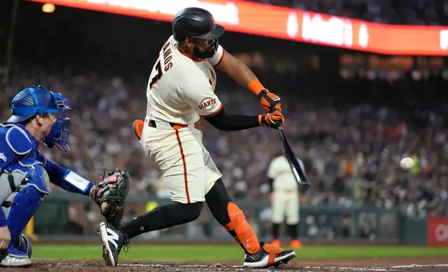 San Francisco Giants' Heliot Ramos hits a single against the Los Angeles Dodgers during the fifth inning of a baseball game Wednesday, April 22, 2026, in San Francisco. (AP Photo/Tony Avelar)