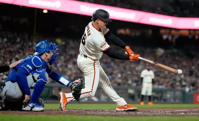 San Francisco Giants' Matt Chapman hits a single during the sixth inning of a baseball game against the Los Angeles Dodgers, Wednesday, April 22, 2026, in San Francisco. (AP Photo/Tony Avelar)