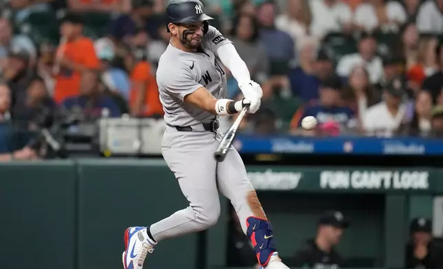 New York Yankees' José Caballero (72) hits a home run against Houston Astros relief pitcher Colton Gordon during the seventh inning of a baseball game, Friday, April 24, 2026, in Houston. (AP Photo/ Karen Warren)