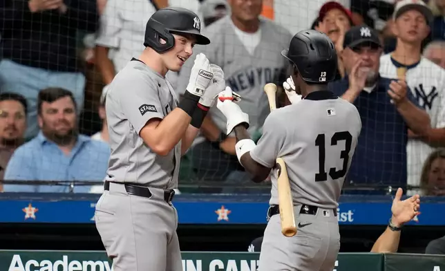 New York Yankees' Ben Rice, left, celebrates after his home run with Jazz Chisholm Jr. (13) during the seventh inning of a baseball game against the Houston Astros, Friday, April 24, 2026, in Houston. (AP Photo/Karen Warren)