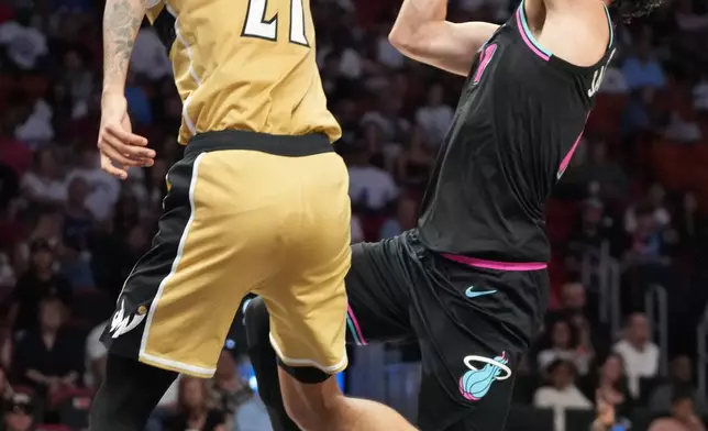 Washington Wizards guard Will Riley (27) defends Miami Heat forward Jaime Jaquez Jr. (11) during the second half of an NBA basketball game Saturday, April 4, 2026, in Miami. (AP Photo/Marta Lavandier)