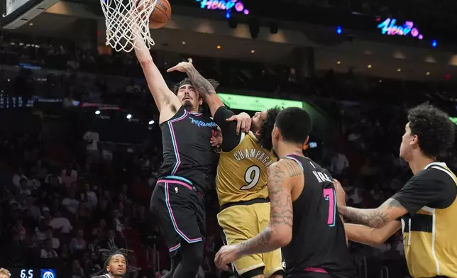 Miami Heat forward Jaime Jaquez Jr. (11) drives to the basket as Washington Wizards forward Justin Champagnie (9) defends during the second half of an NBA basketball game Saturday, April 4, 2026, in Miami. (AP Photo/Marta Lavandier)