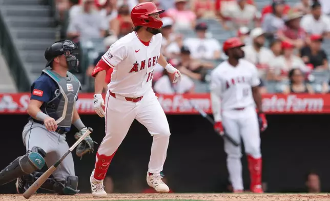Los Angeles Angels' Nolan Schanuel drops his bat after hitting a sacrifice fly to score Adam Frazier during the 11th inning of a baseball game against the Seattle Mariners, Sunday, April 5, 2026, in Anaheim, Calif. (AP Photo/Jessie Alcheh)