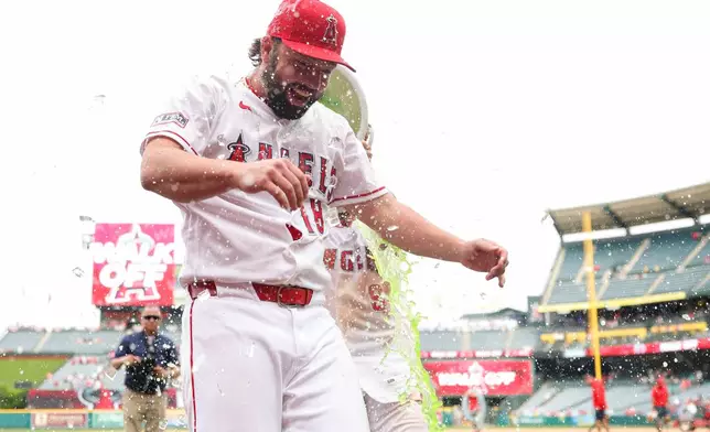 Los Angeles Angels' Zach Neto, back, dumps Gatorade on Nolan Schanuel (18) after the Angels defeated the Mariners in baseball game, Sunday, April 5, 2026, in Anaheim, Calif. (AP Photo/Jessie Alcheh)