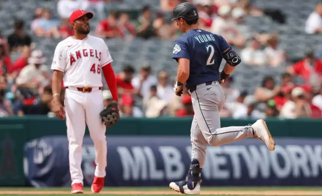 Seattle Mariners' Cole Young (2) rounds the bases after hitting a home run as Los Angeles Angels third baseman Jeimer Candelario (46) watches during the fifth inning of a baseball game, Sunday, April 5, 2026, in Anaheim, Calif. (AP Photo/Jessie Alcheh)
