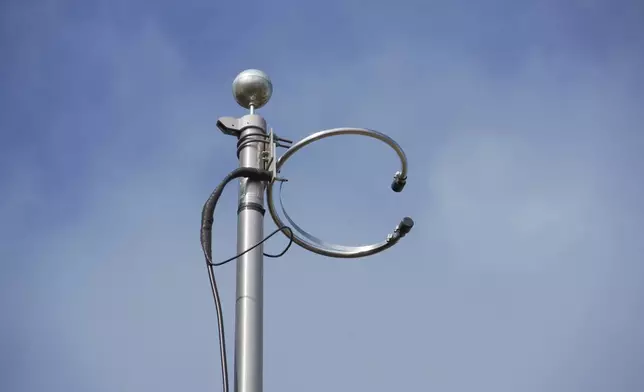 The WKRP radio antenna sits atop a 25-foot flagpole behind D.P. McIntire's home in Raleigh, N.C., on Thursday, April 2, 2026. (AP Photo/Allen G. Breed)