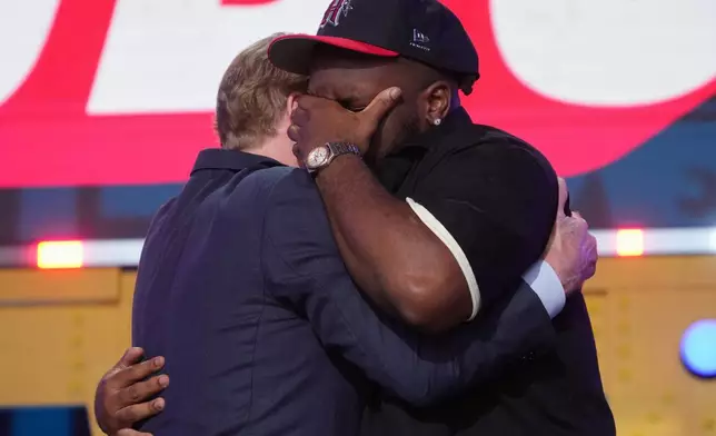 Ohio State defensive lineman Kayden McDonald, right, reacts with NFL Commissioner Roger Goodell after being chosen by the Houston Texans with the 36th overall pick during the second round of the NFL football draft, Friday, April 24, 2026, in Pittsburgh. (AP Photo/Gene J. Puskar)