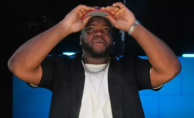 Ohio State defensive lineman Kayden McDonald puts on a hat after being chosen by the Houston Texans with the 36th overall pick during the second round of the NFL football draft, Friday, April 24, 2026, in Pittsburgh. (AP Photo/Jeff Roberson)