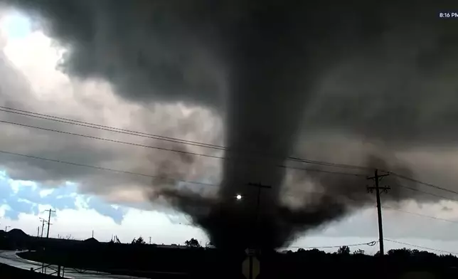In this image taken from video from KWTV/KOTV, a tornado crosses a highway in Enid, Okla., Thursday, April 23, 2026. (KWTV/KOTV via AP)