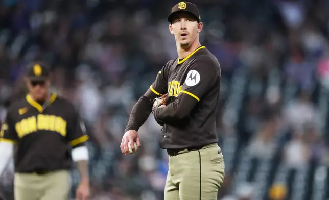San Diego Padres starting pitcher Walker Buehler waits to be pulled form the mound after issuing a walk too Colorado Rockies' Willi Castro in the third inning of a baseball game Wednesday, April 22, 2026, in Denver. (AP Photo/David Zalubowski)