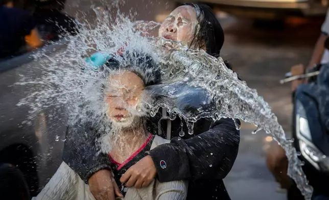 People participate in the Songkran water festival to celebrate the Thai New Year in Prachinburi province, Thailand, Monday, April 13, 2026. (AP Photo/Wason Wanichakorn)