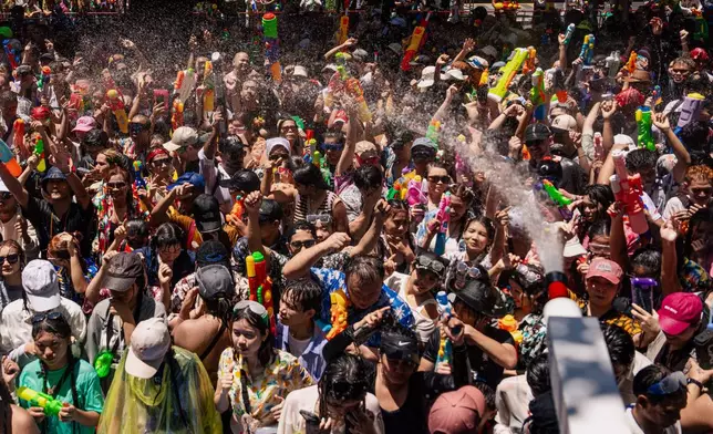 Peoples participate in the Songkran water festival to celebrate the Thai New Year in Bangkok, Thailand, Monday, April 13, 2026. (AP Photo/Arnun Chonmahatrakool)