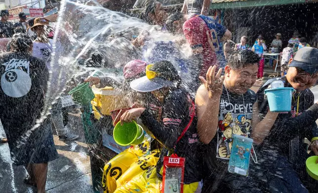 People participate in the Songkran water festival to celebrate the Thai New Year in Prachinburi province, Thailand, Monday, April 13, 2026. (AP Photo/Wason Wanichakorn)