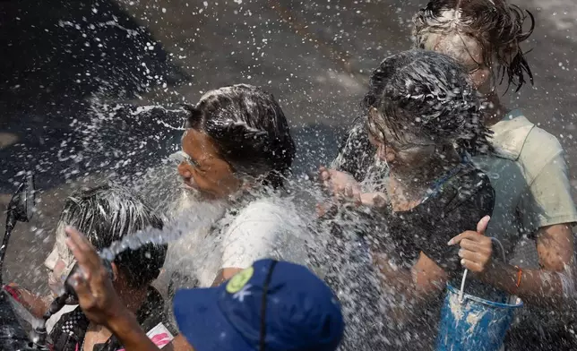 People participate in the Songkran water festival to celebrate the Thai New Year in Prachinburi province, Thailand, Monday, April 13, 2026. (AP Photo/Wason Wanichakorn)