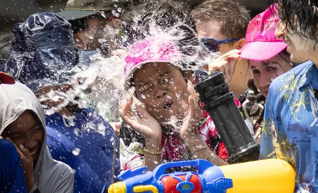 People participate in the Songkran water festival to celebrate the Thai New Year in Prachinburi province, Thailand, Monday, April 13, 2026. (AP Photo/Wason Wanichakorn)