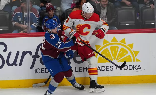 Colorado Avalanche right wing Logan O'Connor, left, checks Calgary Flames defenseman Olli Maatta, right, in the first period of an NHL hockey game Thursday, April 9, 2026, in Denver. (AP Photo/David Zalubowski)