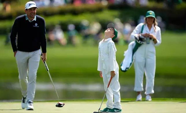 Keegan Bradley, left, watches his son, Logan James, react to his shot on the third hole during par-3 contest ahead of the Masters golf tournament at the Augusta National Golf Club, Wednesday, April 8, 2026, in Augusta, Ga. (AP Photo/Ashley Landis)