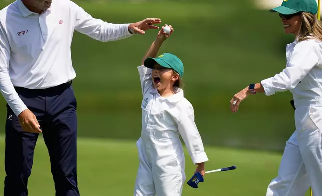 Sergio Garcia's daughter, Azalea, center, celebrates her shot on the eighth hole during par-3 contest ahead of the Masters golf tournament at the Augusta National Golf Club, Wednesday, April 8, 2026, in Augusta, Ga. (AP Photo/Eric Gay)