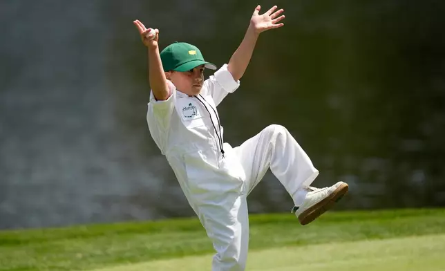 Jason Day's son, Arrow, celebrates on the ninth hole during par-3 contest ahead of the Masters golf tournament at the Augusta National Golf Club, Wednesday, April 8, 2026, in Augusta, Ga. (AP Photo/Gerald Herbert)