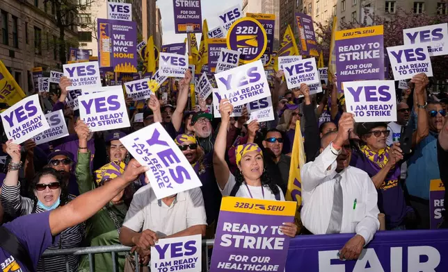 Members of the 32BJ SEIU union vote to authorize a strike during a rally on Park Avenue, in New York, Wednesday, April 15, 2026. (AP Photo/Seth Wenig)