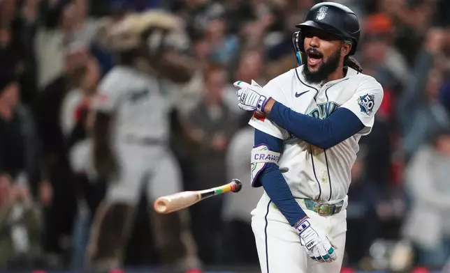 Seattle Mariners' J.P. Crawford reacts to hitting a game-winning RBI single to score Cole Young against the Houston Astros during the ninth inning of a baseball game, Saturday, April 11, 2026, in Seattle. (AP Photo/Lindsey Wasson)