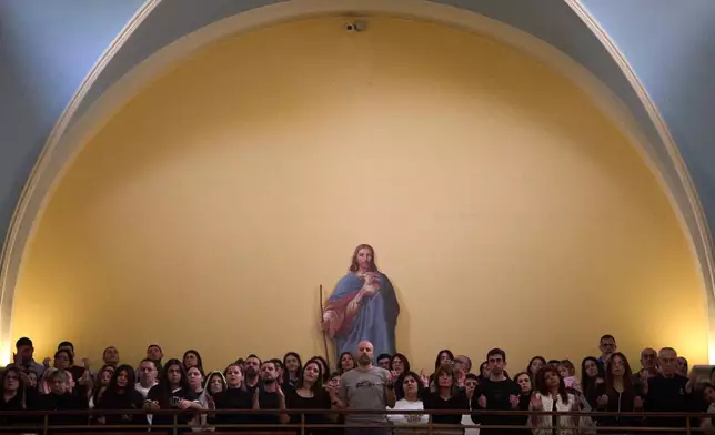 Worshipers pray during Good Friday Mass at St. Anthony Church, which was devoted to expressing solidarity with Christian villagers in southern Lebanon displaced by the war in Jdeideh, a suburb of Beirut, Lebanon, Friday, April 3, 2026. (AP Photo/Emilio Morenatti)