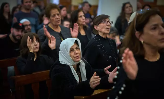Worshipers pray during Good Friday Mass at St. Anthony Church, which was devoted to expressing solidarity with Christian villagers in southern Lebanon displaced by the war in Jdeideh, a suburb of Beirut, Lebanon, Friday, April 3, 2026. (AP Photo/Emilio Morenatti)