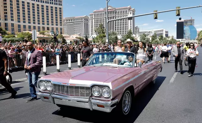 Bruno Mars, center, rides in a parade on the Las Vegas Strip Friday, April 10, 2026, in Las Vegas, on "Bruno Mars Day." (Steve Marcus/Las Vegas Sun via AP)