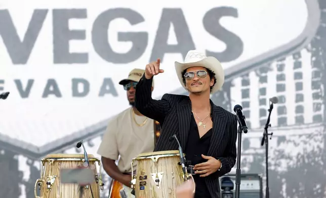 Bruno Mars performs for fans in Toshiba Plaza after a parade down the Las Vegas Strip Friday, April 10, 2026, in Las Vegas, on "Bruno Mars Day." (Steve Marcus/Las Vegas Sun via AP)