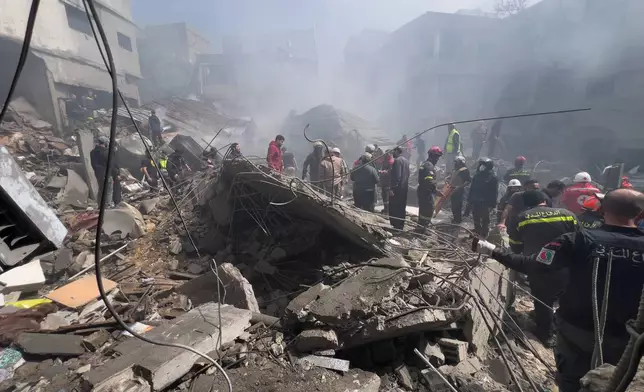 Rescue workers search for victims at the site of an Israeli airstrike that hit a crowded neighbourhood south of Beirut, Lebanon, Sunday, April 5, 2026. (AP Photo/Hussein Malla)