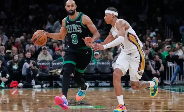 Boston Celtics guard Derrick White (9) drives to the basket against New Orleans Pelicans guard Jeremiah Fears, right, during the second half of an NBA basketball game, Friday, April 10, 2026, in Boston. (AP Photo/Charles Krupa)