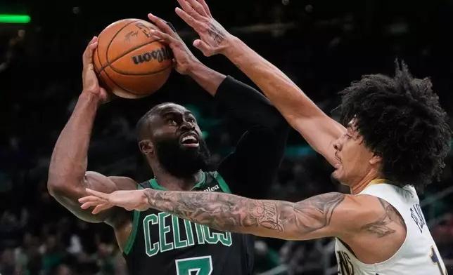 Boston Celtics guard Jaylen Brown (7) drives to the basket against New Orleans Pelicans guard Micah Peavy, right, during the second half of an NBA basketball game, Friday, April 10, 2026, in Boston. (AP Photo/Charles Krupa)