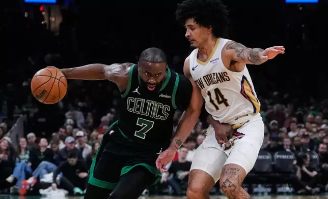 Boston Celtics guard Jaylen Brown (7) drives to the basket against New Orleans Pelicans guard Micah Peavy (14) during the second half of an NBA basketball game, Friday, April 10, 2026, in Boston. (AP Photo/Charles Krupa)