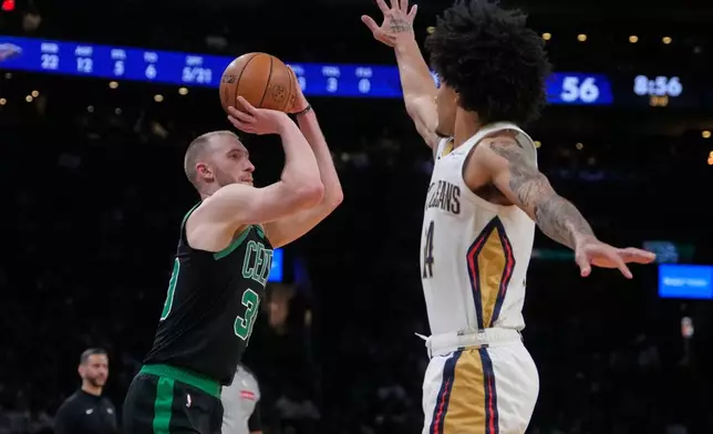 Boston Celtics forward Sam Hauser (30) takes a 3-point shot over New Orleans Pelicans guard Micah Peavy during the second half of an NBA basketball game, Friday, April 10, 2026, in Boston. (AP Photo/Charles Krupa)