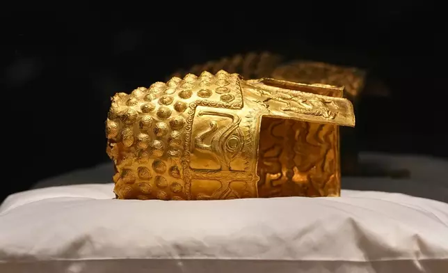 Dacian gold items, a 2,500-year-old helmet and wristbands, stolen from a museum in the Netherlands and then recovered by Dutch authorities, are presented during a press conference after being returned, at the National Museum of Romanian History, in Bucharest, Romania, Tuesday, April 21, 2026. (AP Photo/Andreea Alexandru)