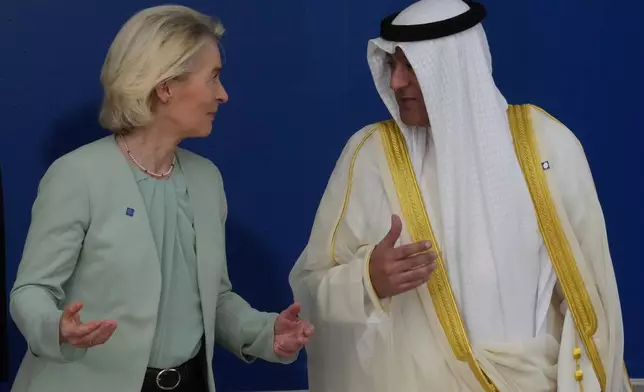 European Commission President Ursula von der Leyen, left, speaks with the Gulf Cooperation Council Secretary General Jasem Mohamed Albudaiwi before a family photo of the EU Summit in Nicosia, Cyprus, Friday, April 24, 2026. (AP Photo/Petros Karadjias)