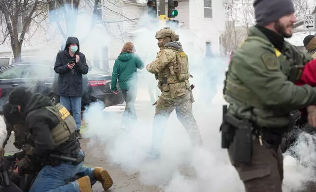 FILE - Tear gas is deployed as federal agents make arrests, Jan. 21, 2026, in Minneapolis. (AP Photo/Angelina Katsanis, File)