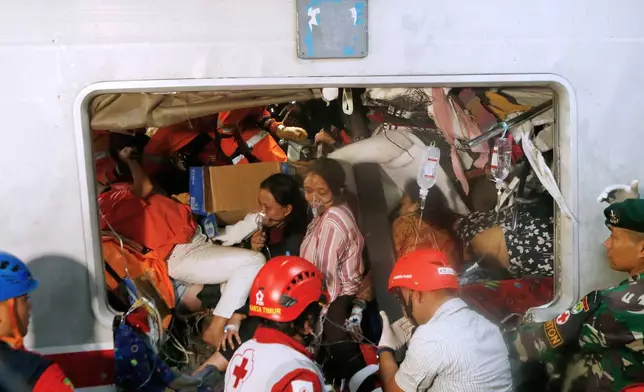 Passengers are being rescued after a train collision in Bekasi, Indonesia, Tuesday, April 28, 2026. (AP Photo)