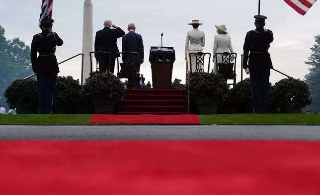 President Donald Trump, from left, King Charles III, first lady Melania Trump and Queen Camilla stand on stage during an arrival ceremony on the South Lawn of the White House, Tuesday, April 28, 2026, in Washington. (AP Photo/Julia Demaree Nikhinson)
