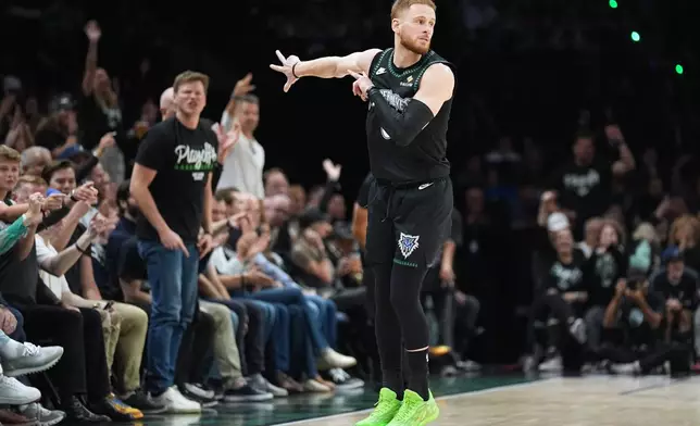 Minnesota Timberwolves guard Donte DiVincenzo (0) celebrates after making a 3-point shot during the first half in Game 3 of a first-round NBA basketball playoff series against the Denver Nuggets, Thursday, April 23, 2026, in Minneapolis. (AP Photo/Abbie Parr)