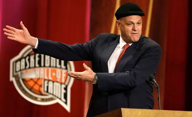 FILE - Inductee Oscar Schmidt, of Brazil, speaks during the enshrinement ceremony for this year's class of the Basketball Hall of Fame, at Symphony Hall in Springfield, Mass., Sept. 8, 2013. Schmidt, whom his Brazil compatriots know as the “Holy Hand,” died. Friday, April 17, 2026. He was 68. (AP Photo/Steven Senne, File)