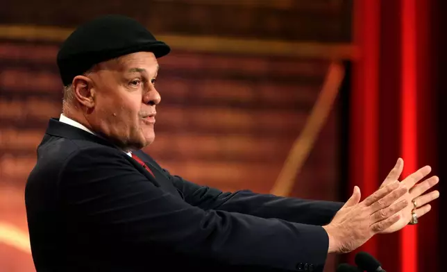 FILE - Inductee Oscar Schmidt, of Brazil, speaks during the enshrinement ceremony for the 2013 class of the Naismith Memorial Basketball Hall of Fame at Symphony Hall in Springfield, Mass., Sept. 8, 2013. Schmidt, whom his Brazil compatriots know as the “Holy Hand,” died. Friday, April 17, 2026. He was 68. (AP Photo/Steven Senne, File)
